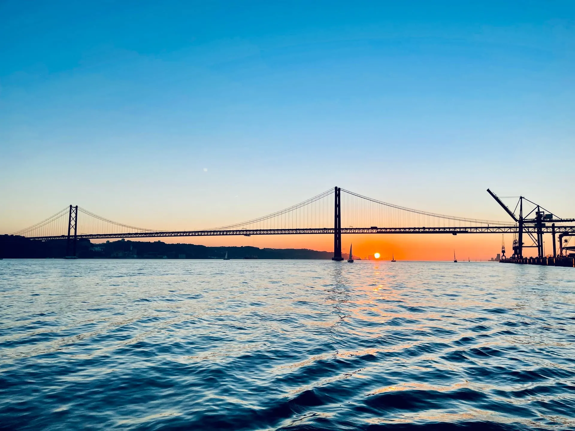 Ponte 25 de Abril o zachodzie słońca – widok z Tejo